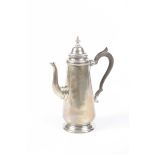 A hallmarked silver coffee pot, Chester 1923 Having a domed hinged cover and knopped finial above