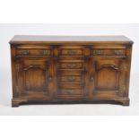 A lovely quality George III style oak dresser base, 20th Century The rectangular moulded crossbanded