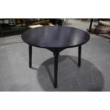 A painted circular kitchen table Raised upon turned legs. Diameter 110cm.