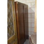 A mid 20th Century oak gents two door wardrobe The two doors enclosing a fitted interior,