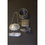 A selection of silver To include a silver vesta case, a spirit label, a silver pocket knife and a