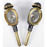 A pair of late 19th Century carriage lamps Of typical form with brass stems (length 49cm) (2)