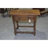 A 17th Century style oak side table, mid 20th Century Having a rectangular slab top above single