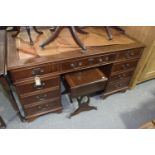 A reproduction mahogany twin pedestal writing desk Having a leather inset writing surface (af) above