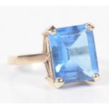 A 9ct gold blue topaz single stone ring The rectangular shape blue topaz within a four claw setting,