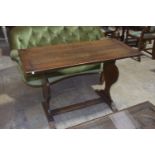 An early 20th Century oak Arts and Crafts side table The rectangular cleated plank top supported