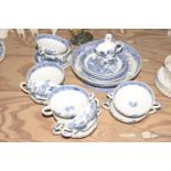 A Wedgwood 'Willow pattern' part service To include 11 twin handled soup bowls, pedestal cake