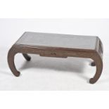 A carved hardwood Kang table, 20th Century The rectangular top carved in deep relief depicting