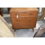 A mid 20th Century oak chest of drawer With three graduated drawers each applied with hardwood