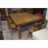A 19th Century pine farmhouse kitchen table The rectangular plank top with canted corners above a