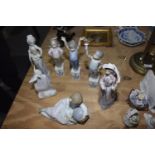 A collection of Lladro figures To include a girl cradling the earth, a Lladro Society ceramic