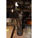 An early 20th Century Spelter figure Modeled holding a torch aloft and an industrial cog raised upon