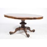 A Victorian burr walnut loo table The quatrefoil moulded and quarter veneered top raised upon a