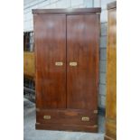 A yew wood campaign style wardrobe, 20th Century Having a plain cornice above two cupboard doors