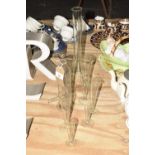 A collection of glass scientific test tubes Each of various form all measuring in Fl Oz. Tallest