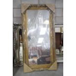 A French Louis XVI style gilt framed wall mirror Having a rectangular bevelled plate within an