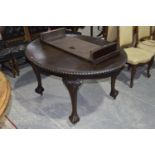 An early 20th Century Chippendale revival mahogany extending dining table The oval extending top