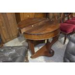 A near pair of Victorian mahogany demi lune tables Each table with a plain frieze supported on a