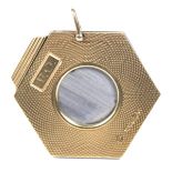 A 9ct gold cigar cutter Of hexagonal form, the engine turned frame with rectangular cartouche