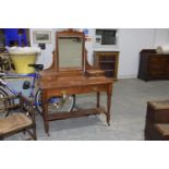 A Victorian walnut dressing table Having a rectangular mirrored beveled plated above two small