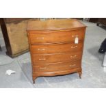 A reproduction yew wood bow front chest of drawers Having four cock beaded drawers each applied with