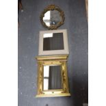 A group of three wall mirrors The first of oval form with floral leafy frame (height 67cm) The