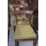 A pair of William IV rosewood dining chairs Each chair with a carved crest rail terminating in leafy