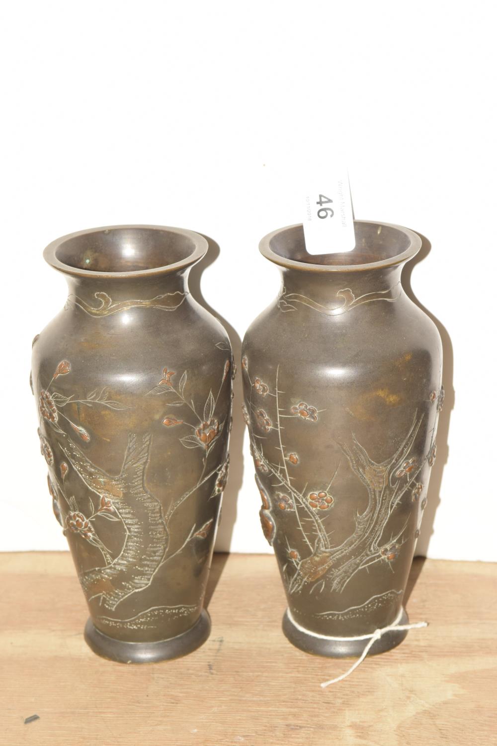 A pair of bronze Japanese vases, 20th Century The 18cm high vases decorated in relief with foliate