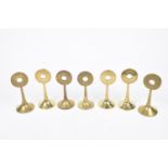 A group of early 20th Century cast brass subject markers, c.1900 Each rising from a circular