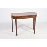 An early 19th Century mahogany folding games table The rectangular folding top with rounded front