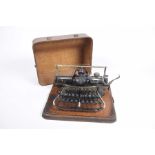An oak cased Blickensderfer Number 7 typewriter, c.1900 The typewriter within a shaped oak case upon