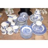 A large collection of blue and white table wares To include Rayware, Willow Pattern cups, saucers