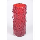 A bark effect glass vase by Geoffrey Baxter The vibrant red vase with bark effect outside (height