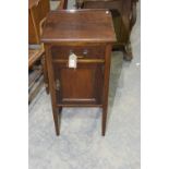 An Edwardian mahogany pot cupboard The square moulded top above a single frieze drawer and a