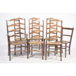 A set of six stained beechwood ladder back country chairs Each chair with four shaped rungs above an