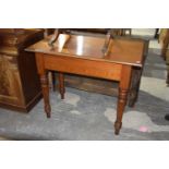 A Victorian pitch pine side table Having a rectangular top above a plain frieze raised on ring