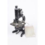 An early 20th Century Watson & Sons microscope The black painted cast metal microscope with