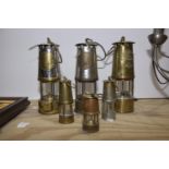 A group of six various miners lamps To include examples from Protector Lamp Company Ltd, Eccles;