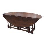 A good quality 18th Century style oak wake table The substantial oval top supported on ring turned