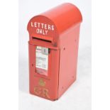 A Royal Mail post mounted iron letter box Of typical arched form painted in red with relief