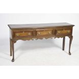 A good quality George III style oak dresser base, 20th Century Having a rectangular moulded top