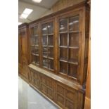 A good quality Georgian style oak glazed bookcase, 20th Century Having a moulded cornice above three