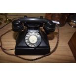 A mid 20th Century Bakelite telephone Of typical form with cord wiring and adapted to be used on