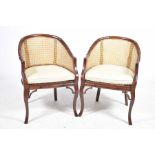 A pair of contemporary stained beech wood and bamboo rattan tub chairs Each chair with an arched