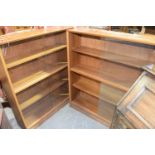 A pair of Gibbs furniture teak glazed bookcases Each bookcase with an arrangement of two sliding