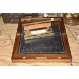 A Victorian walnut stationary box Of hinged form with a leather inset writing slope and