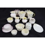 A collection of Belleek ceramics To include three various jugs 9cm, 7.5cm and 9cm, a twin handled