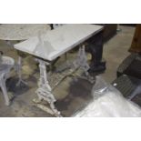 A Victorian cast iron table stand and marble top The rectangular white marble top supported on a