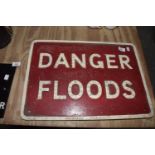 A red and white cast iron road sign The red ground road sign with picked out raised lettering '