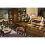 An Edwardian three piece mahogany bedroom suite Comprising a wardrobe with central mirrored door,